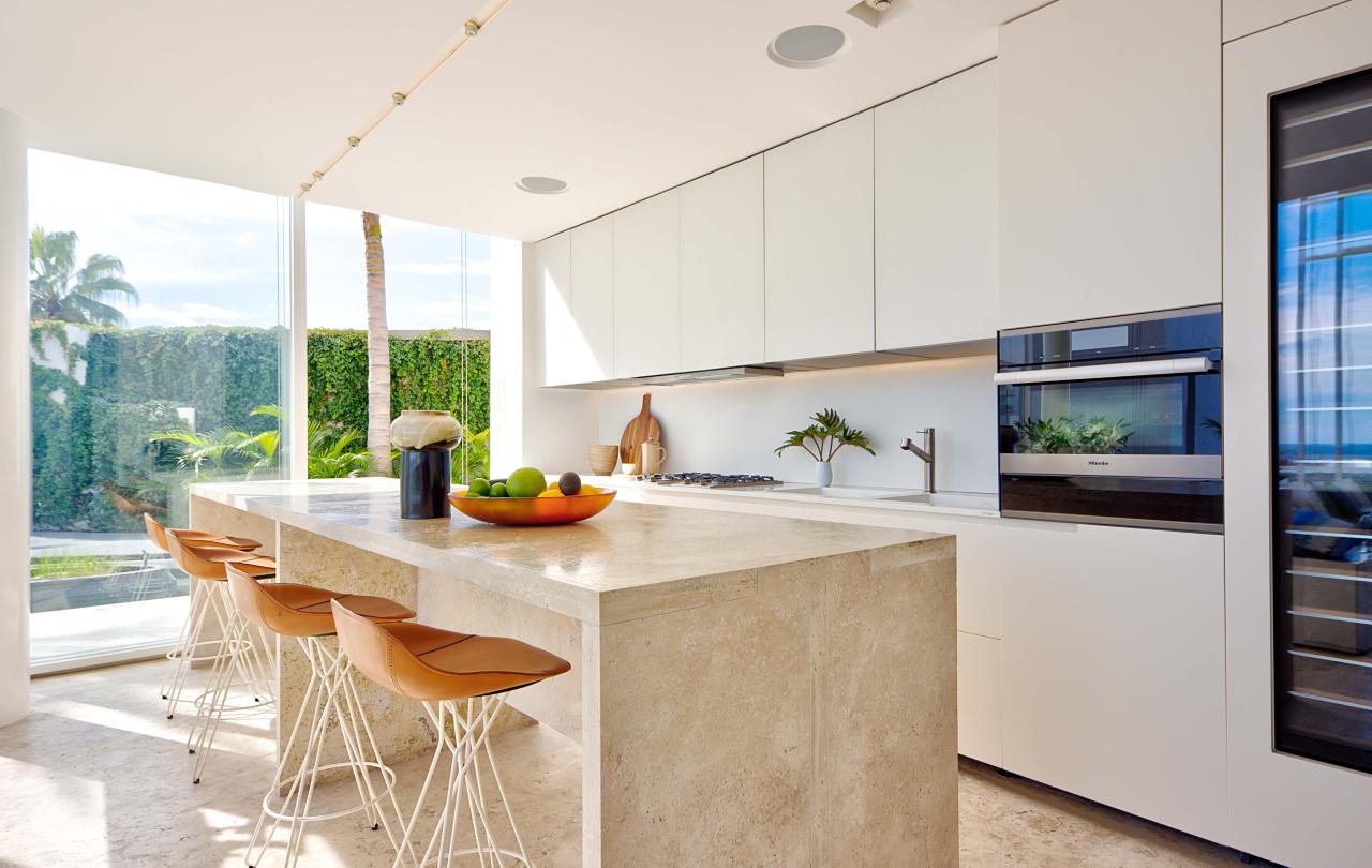 los cabos waterside villa's full kitchen with an island paired with barstools