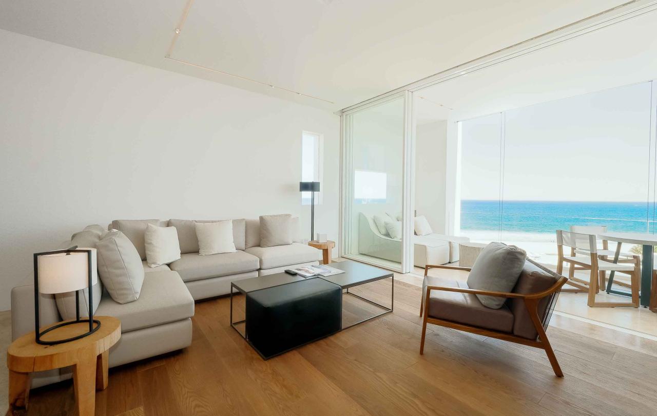 los cabos ocean view living room with couch, coffee table and chair