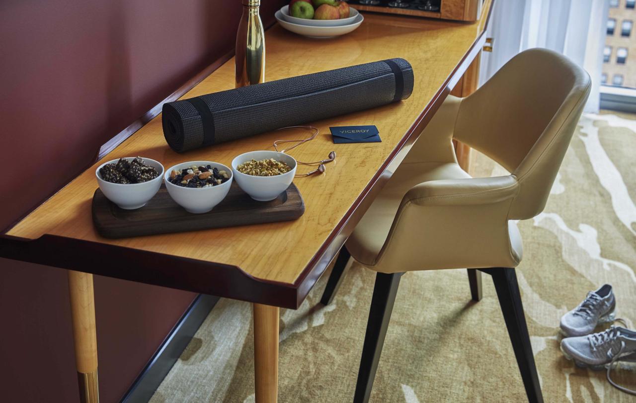 bowls of snacks and personal items on desk and chair inside Superior Room at Viceroy Chicago