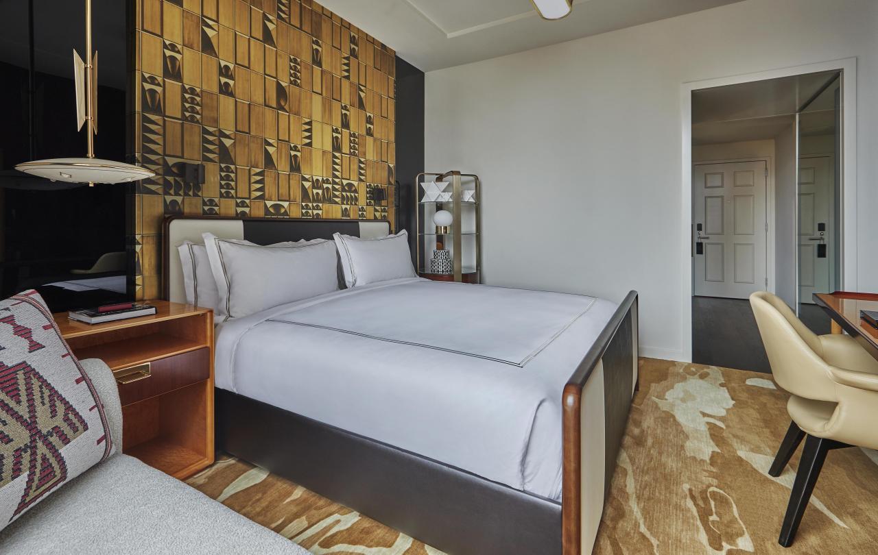 Bedroom with queen bed and desk area