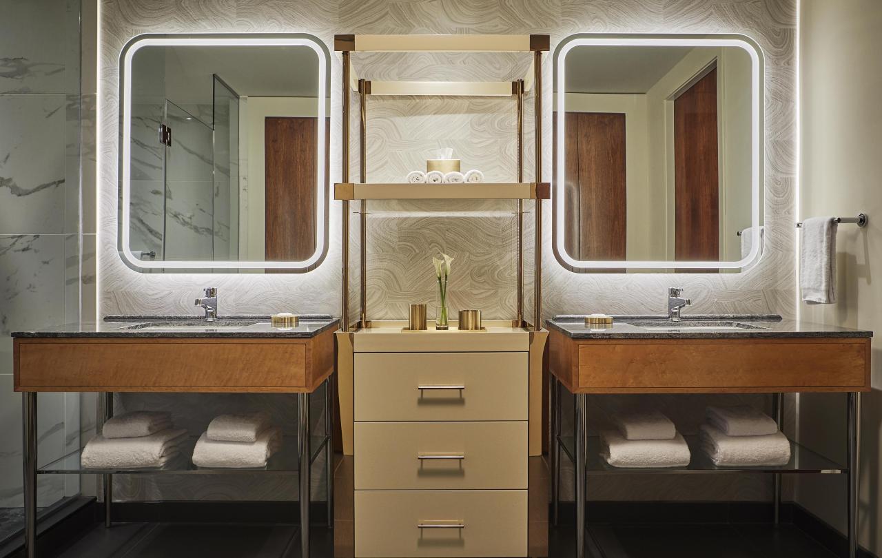 Bathroom with two vanities and a shelving unit
