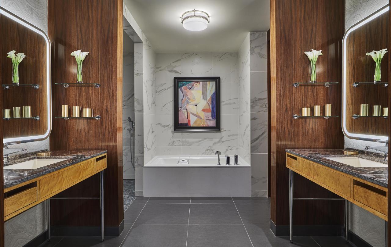 Bathroom with soaking tub, separate shower, enclosed toilet, and a vanity on either side
