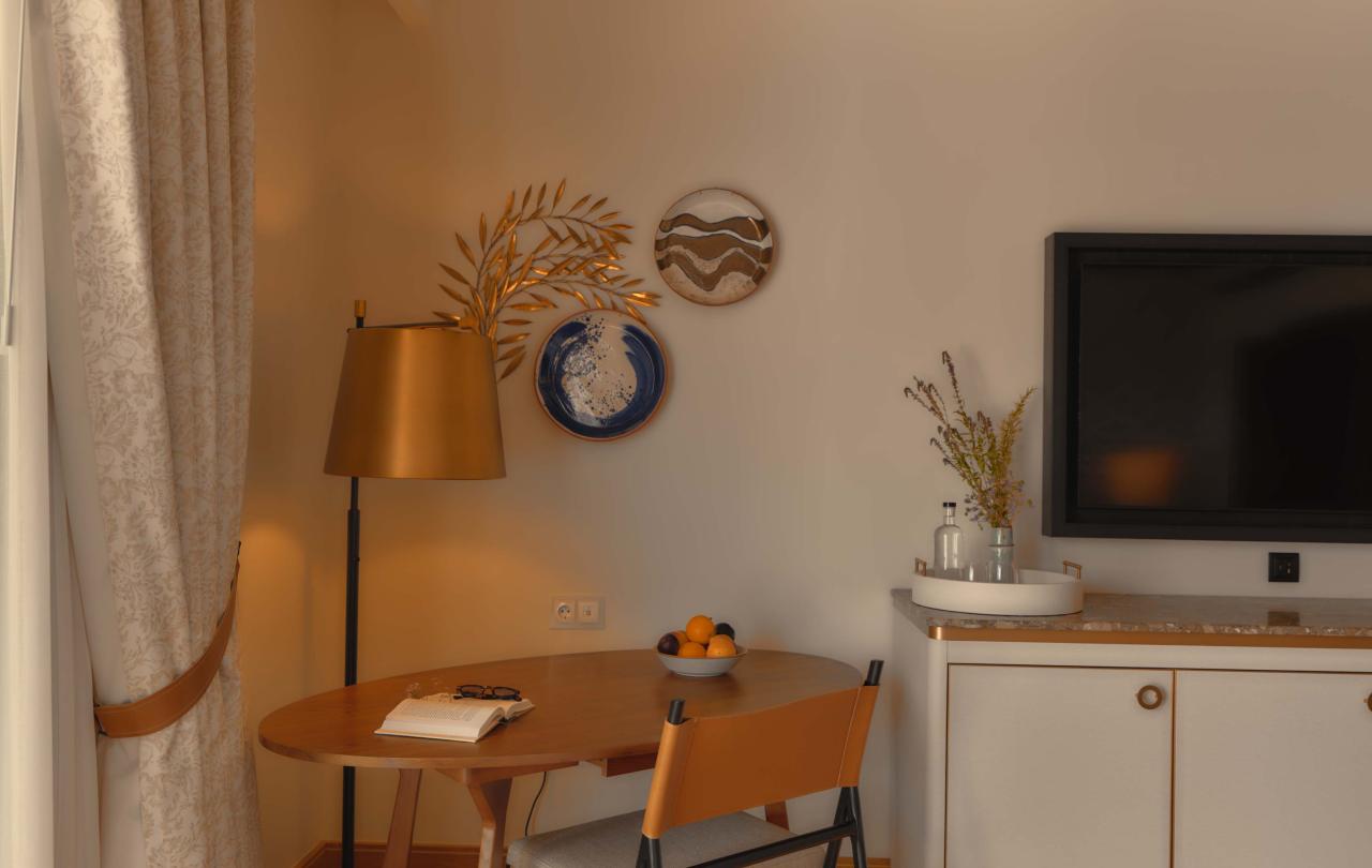 Desk in the corner of the room with a standing lamp