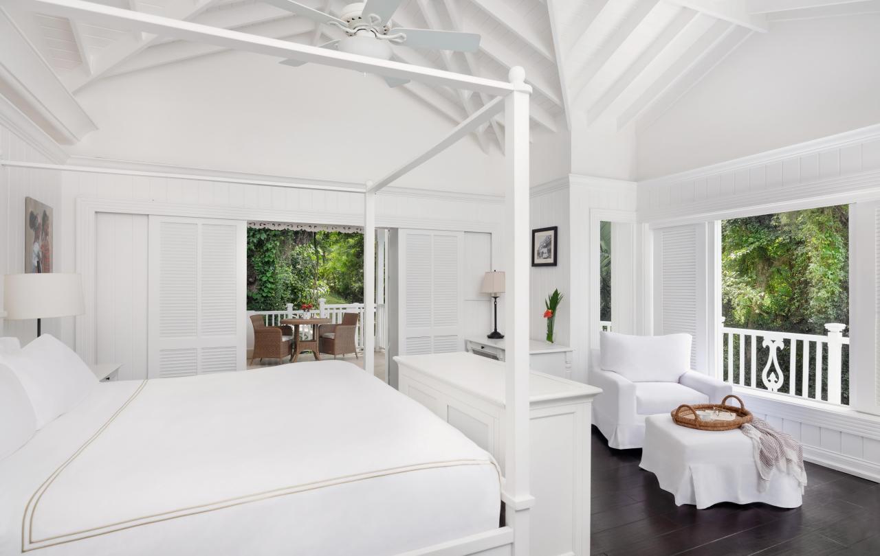 white bedroom with large bed and sitting area