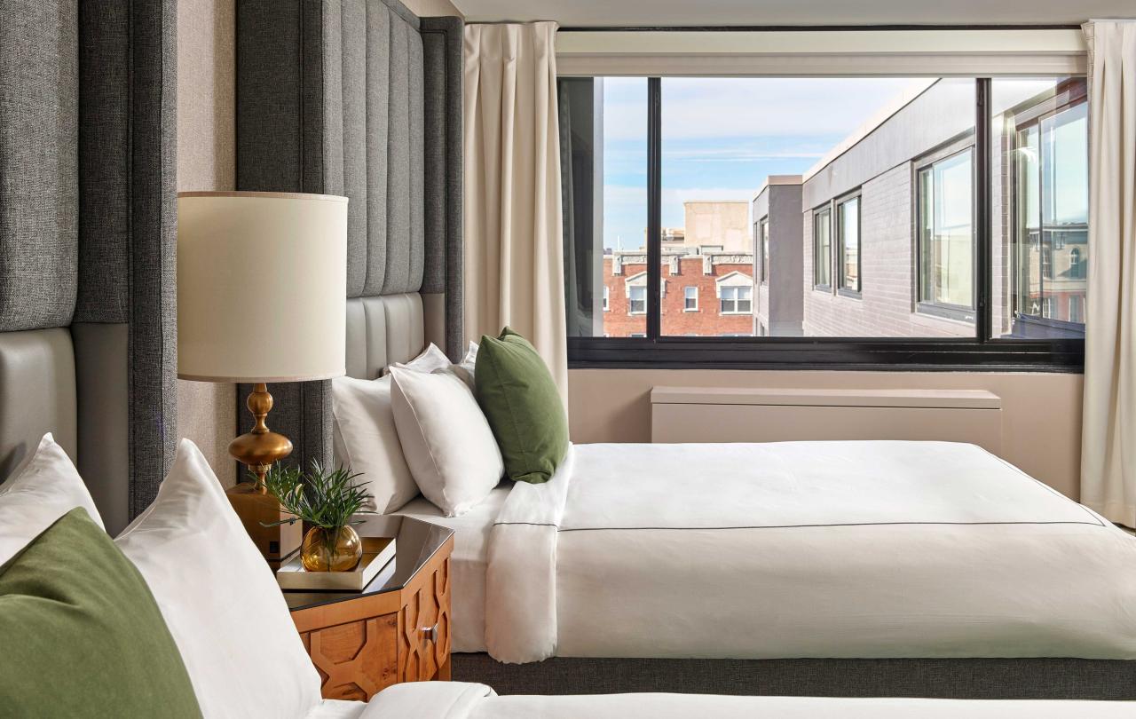 Bedroom with two queen beds and a view of the hotel