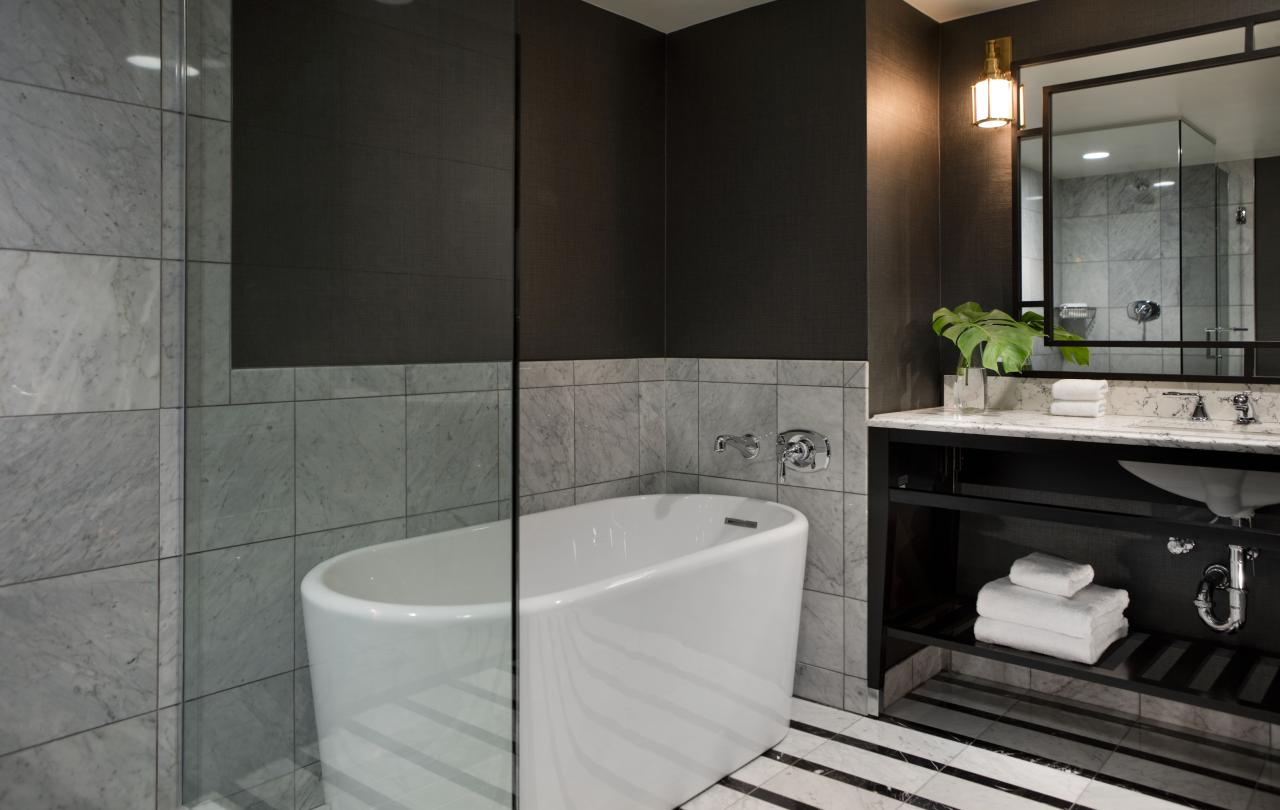 Bathroom with shower and tub separated by a glass wall