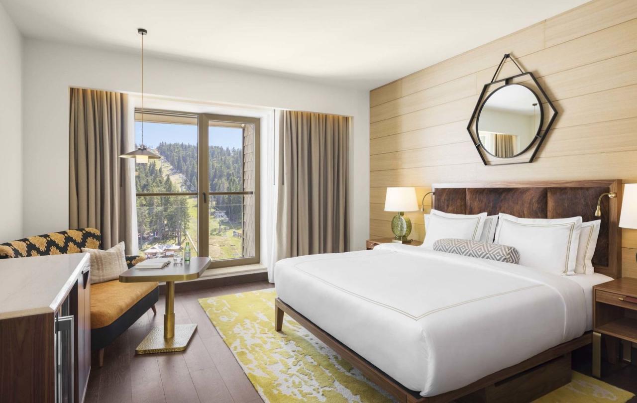 King room with a king bed, couch, dresser and tv at Viceroy Kopaonik Serbia
