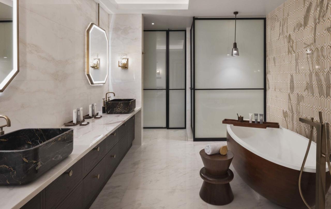 A washroom with a large double sink marble vanity and a soaker tub in a penthouse suite at Viceroy Kopaonik Serbia