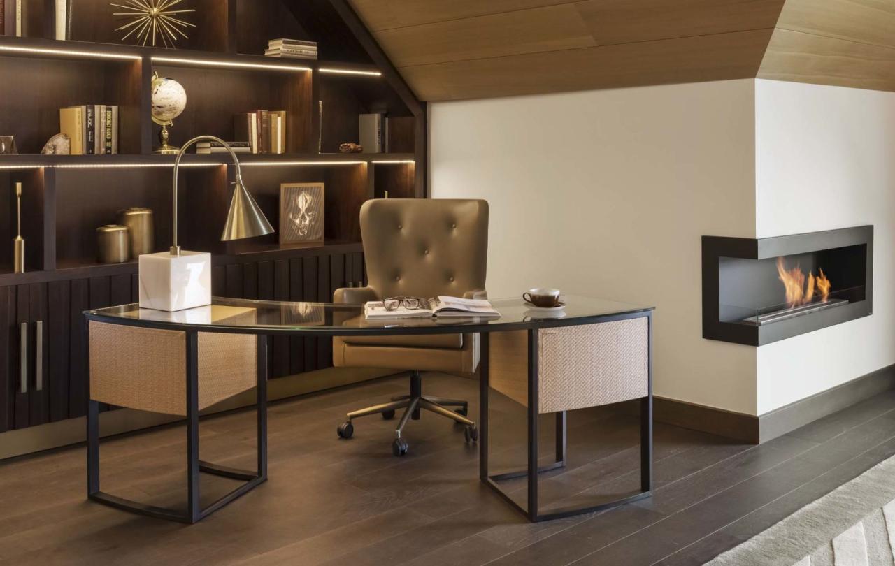 A desk area in a penthouse suite with an in wall fireplace A washroom with a large double sink vanity and a soaker tub in a penthouse suite at Viceroy Kopaonik Serbia