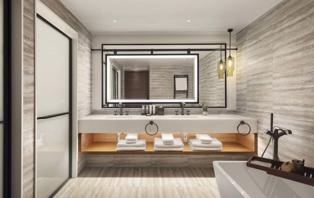 A washroom with a large double sink vanity and a soaker tub in a penthouse suite at Viceroy Kopaonik Serbia