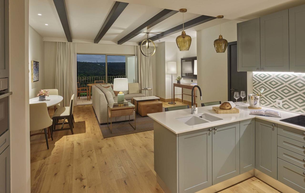 A spacious open kitchen into living room area overlooking a terrace in a residence at Viceroy Ombris Algarve