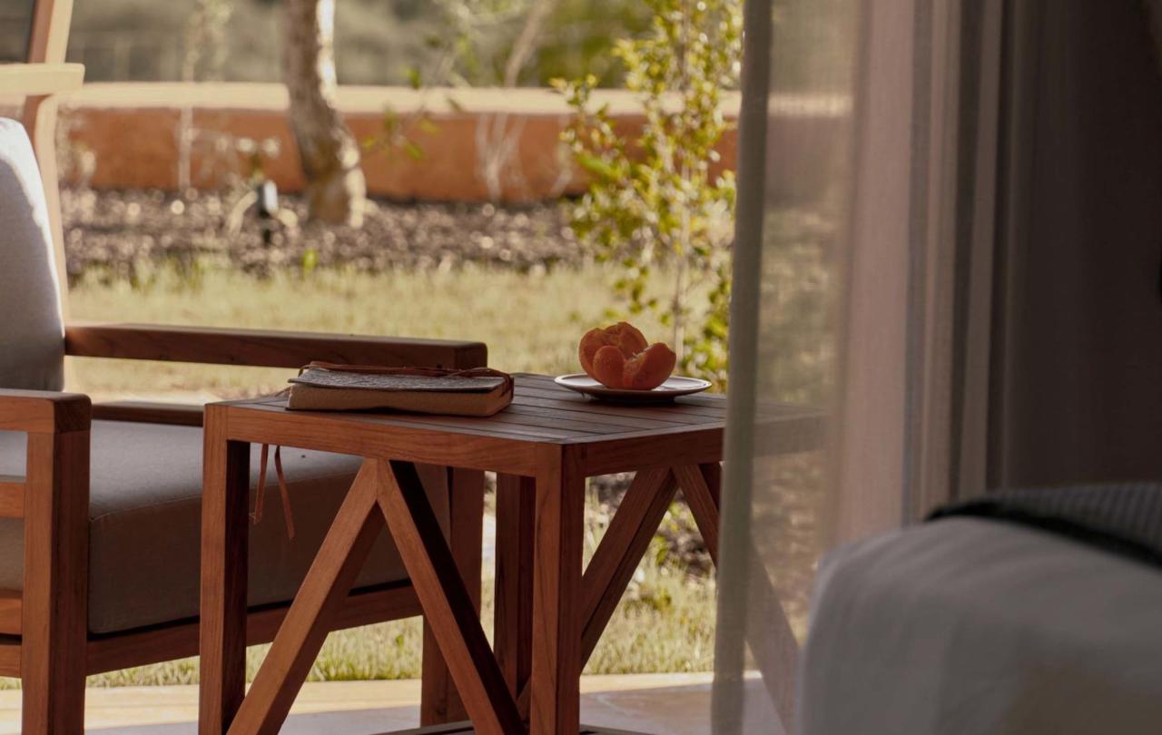a little table and a chair on a terrace in a deluxe king room at Viceroy Ombria Algarve