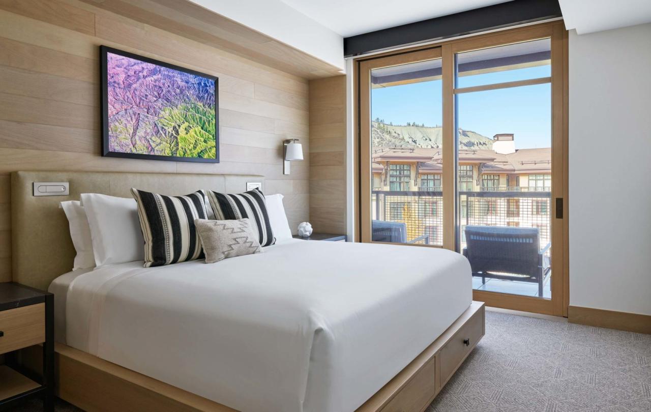 A large King bed looking out on a mountain village