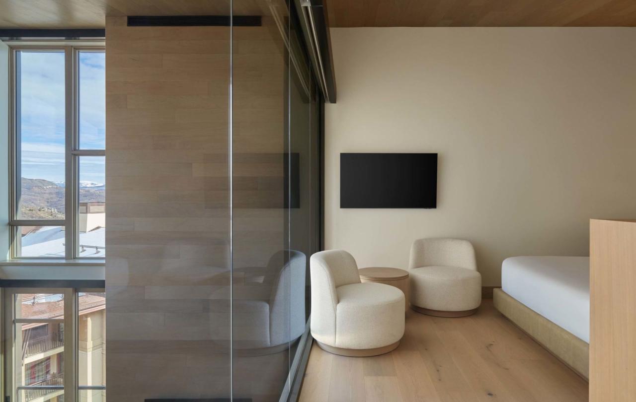 Two modern lounge chairs in the room of a Cirque Two Bedroom Penthouse Loft at Viceroy Snowmass