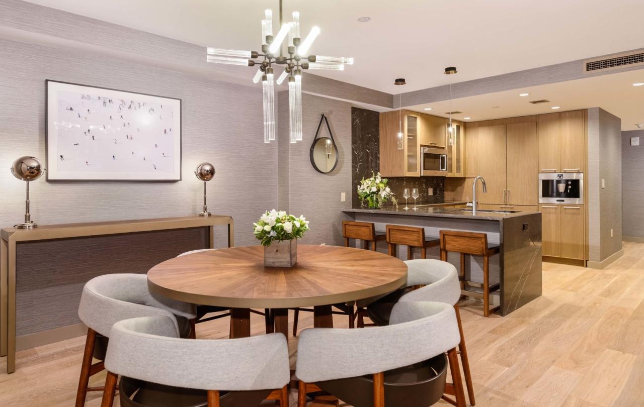 A six person round table and a large kitchen space in a Pinnacle Three Bedroom Penthouse at Viceroy Snowmass