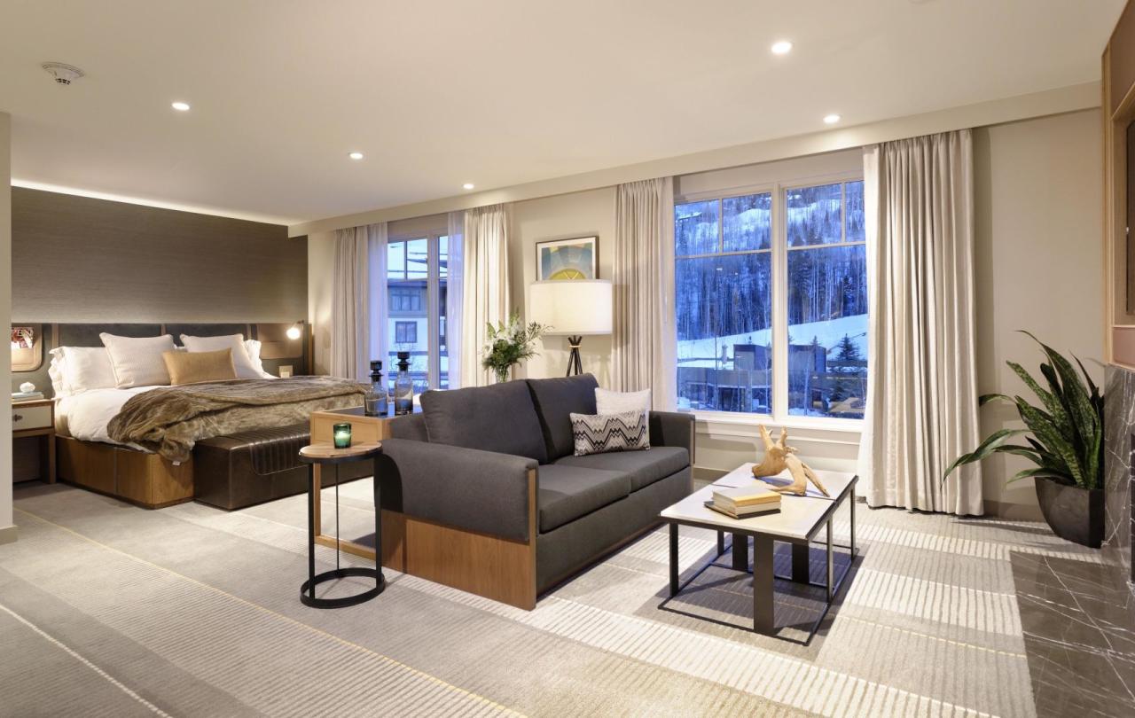 Bedroom with couch and fireplace at Viceroy Snowmass