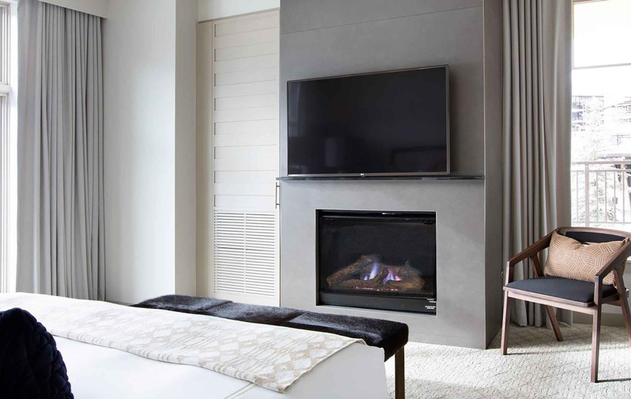The fireplace and TV in a Pinnacle Two Bedroom Premium Residence at Viceroy Snowmass