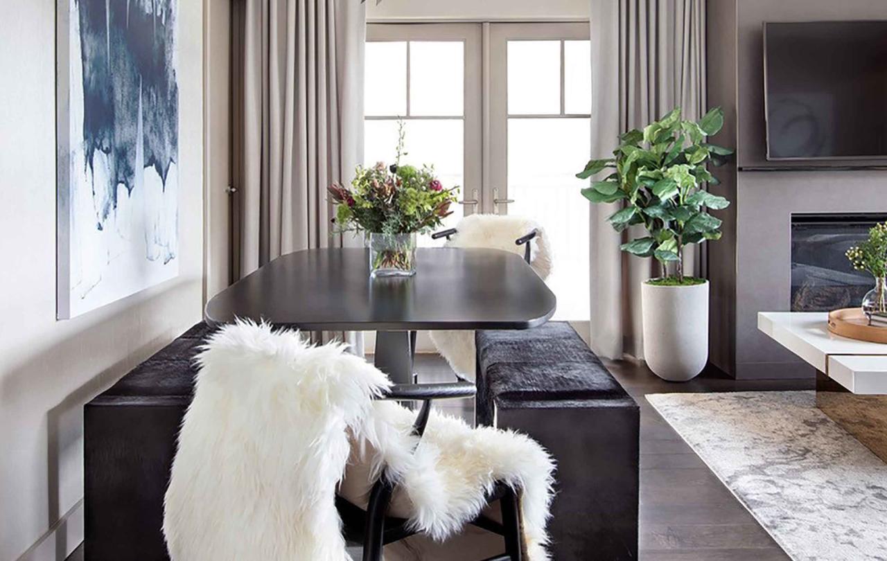 A dining table next the the living room in a Pinnacle Two Bedroom Premium Residence at Viceroy Snowmass
