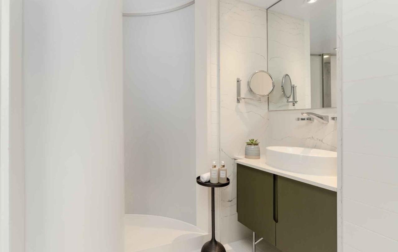 Shower and vanity in a room at Viceroy Zena Washington