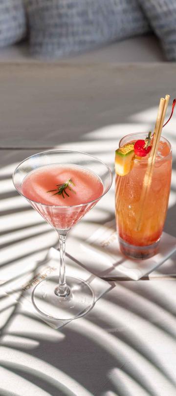two cocktails on an outdoor table
