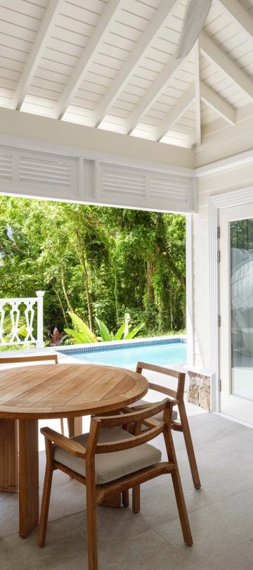 covered patio with dining table and sofa
