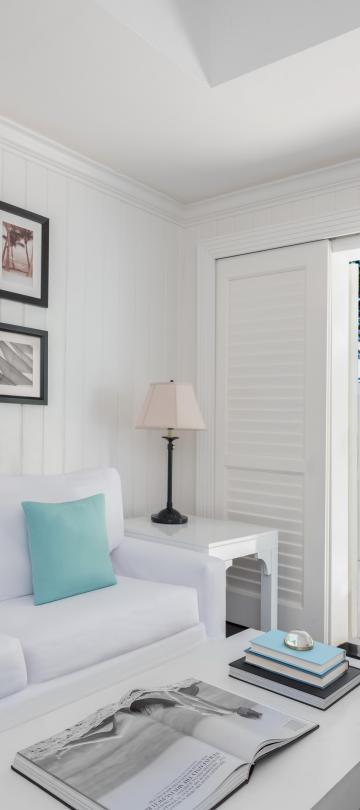 living room with white couch and photos hanging on the wall
