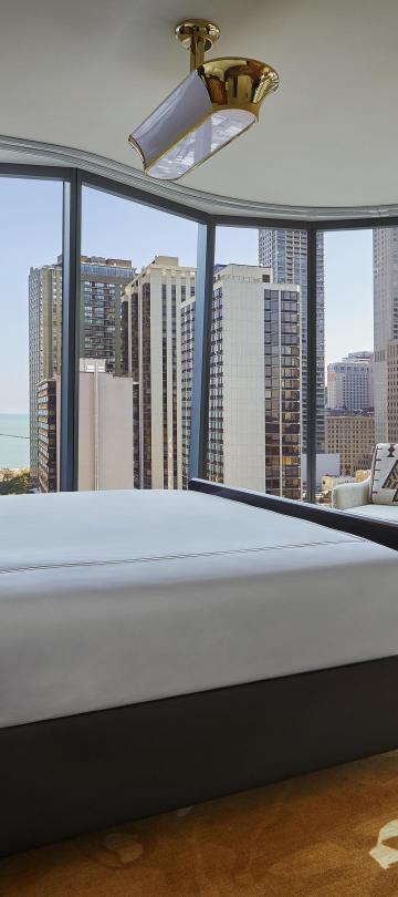 A suite at Viceroy Chicago with floor to ceiling windows and a beautiful view of Chicago 