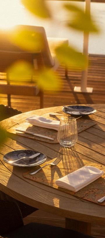 A patio table at Salpico at sunset