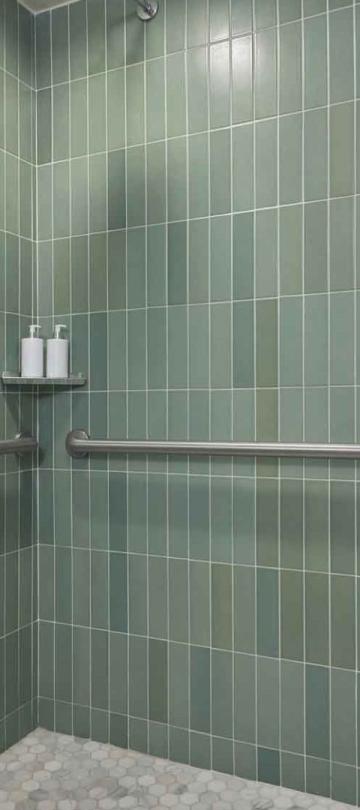 A green tiled shower in a suite at Viceroy Santa Monica