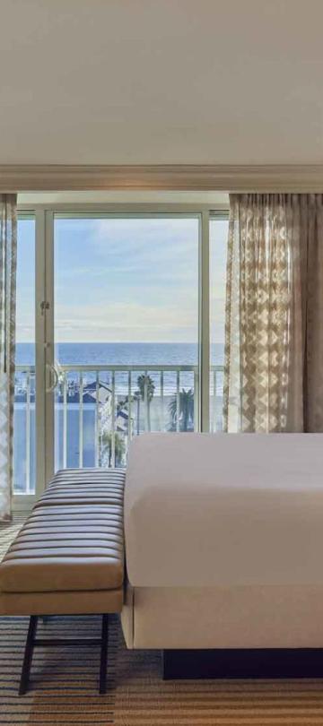A king bed and balcony in a Junior Suite at Viceroy Santa Monica