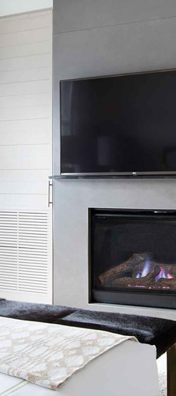 The fireplace and TV in a Pinnacle Two Bedroom Premium Residence at Viceroy Snowmass