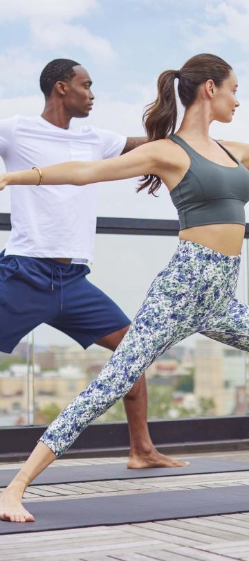 A couple doing yoga on the rooftop of Viceroy Washington DC