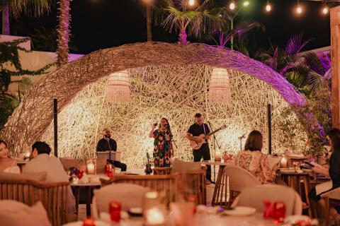 A band performing music to patron at Awacate at Los Cabos