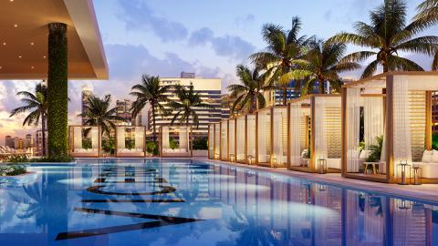 The pool and cabanas, lined with palm tree, at the Viceroy Residences at Fort Lauderdale
