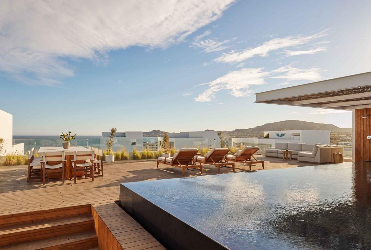 los cabos outdoor wrap pool, dining, and lounging area