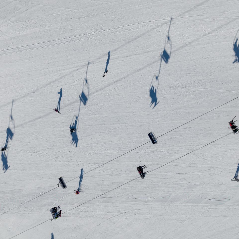 Shadows cast on the snow from a ski lift overhead at Viceroy Snowmass