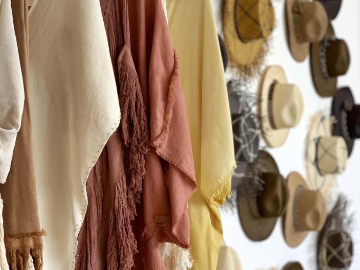 clothing and hats hang on the wall