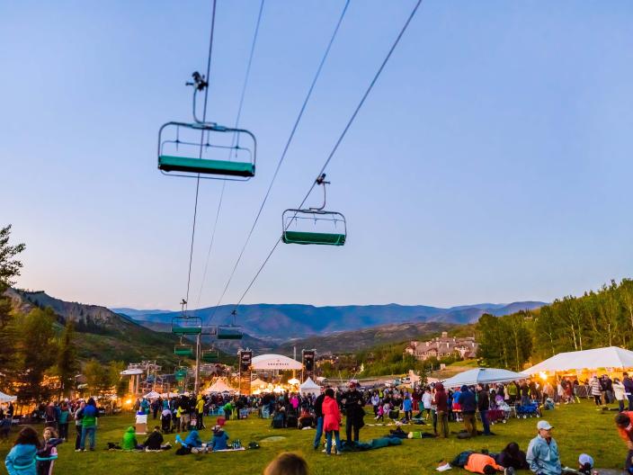 crowds gathered in a field for a concert