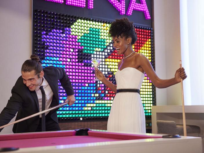 Bride and groom playing pool