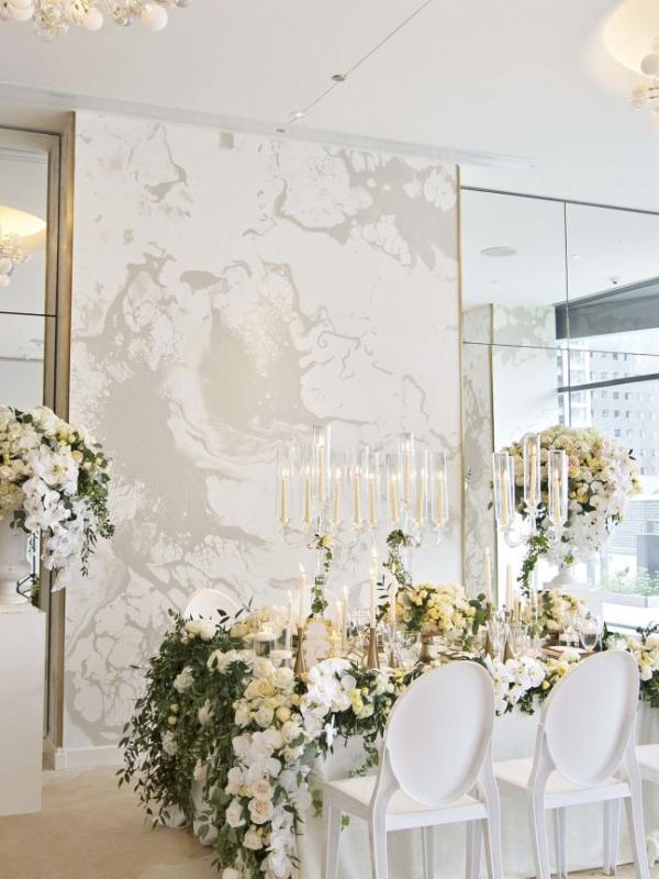 A Room Filled With Furniture And Vase Of Flowers On A Table