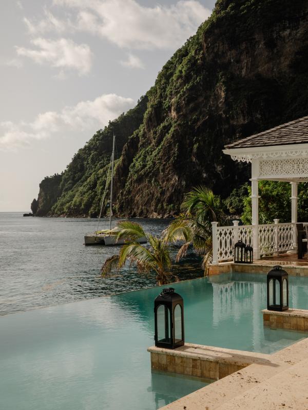 pool near ocean beside mountain