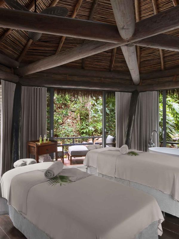 Two massage beds in a hut outside at Viceroy Sugar Beach