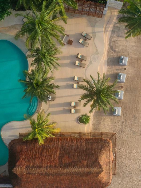 Overhead view of the beach, a pool, and accommodations at Viceroy Riviera Maya
