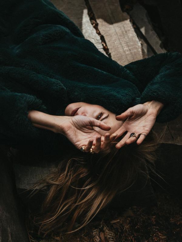 woman with hands above her face